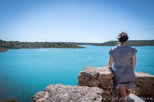 Mujer en la muralla del castillo de Peñarroya, admirando el paisaje del embalse